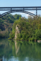 Fototapeta na wymiar Iron bridge over Adda river at Paderno