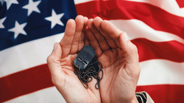Soldier Holds Military Plates. Top view.