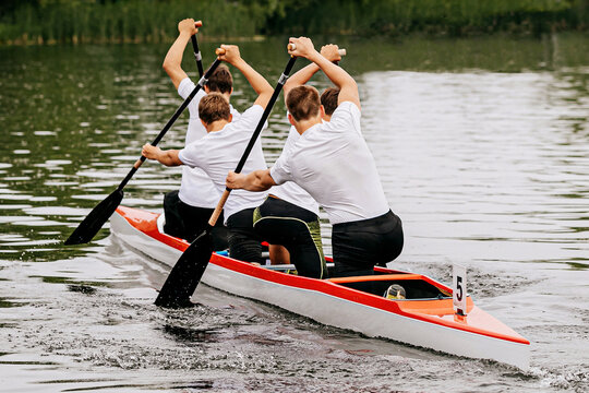 male junior canoeist on canoe four in canoeing competition race, sports summer games