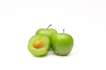 Fresh and green plum on white background