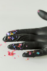 Black gloves covered with glitter for nail art