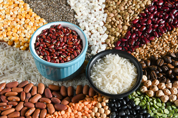 Bowl with raw white rices and beans on various seeds grain