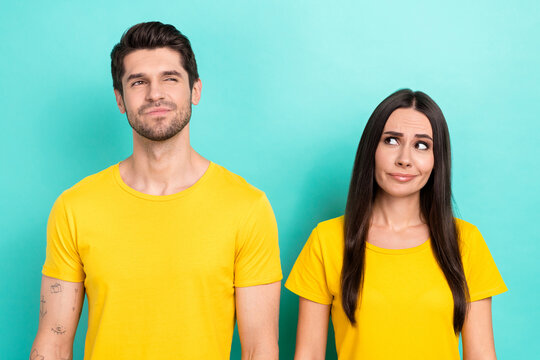 Photo of brainstorming young couple partners wear yellow t-shirt thinking solution how save more money isolated on aquamarine color background