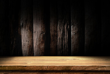 Wooden table in dark room background concept for advertising.