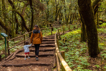 Mother and son enjoying on a path in the natural park of Garajonay in La Gomera, Canary Islands