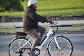 elderly man riding a bicycle,  riding bicycles in the park in the late afternoon, man ride a bicycle at the nature park.
