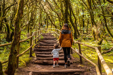 Mother and son trekking on some stairs along a path in the Garajonay natural park on La Gomera,...