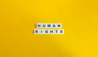 Human Rights Term on Block Letter Tiles on Yellow Background. Minimal Aesthetics.
