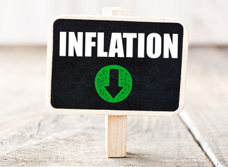 INFLATION green down arrow, decrease in inflation. Concept for business.