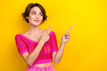 Portrait of cheerful pretty cute lady wear stylish clothes demonstrate empty space summer discount isolated on yellow color background - obrazy, fototapety, plakaty