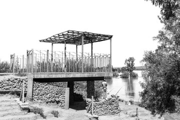 Angler at Samevloeiing where rivers join. Monochrome