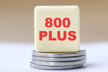 Inscription 800 plus on single block and stack of coins. 800 plus is evaluation of the 500 plus...