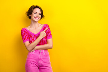 Photo of toothy beaming positive girl dressed off shoulder shirt indicating at promo empty space...