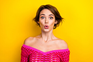 Portrait of nice speechless woman with short haircut wear pink dress astonished staring at big sale isolated on yellow color background