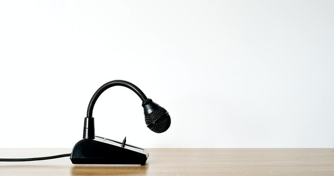 The black desktop microphone wakes up and turns his head. Stop motion animation	