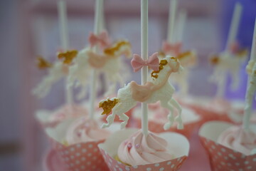 Cute fancy cupcakes. Carousel horse gold and pink cupcakes. Carousel theme party sweets for catering.