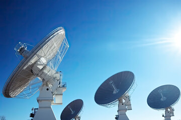 Satellite dishes on the bright blue sky background