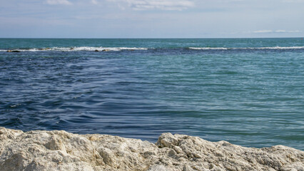 Stone texture in the foreground against the sea