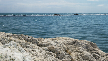 Stone texture in the foreground against the sea