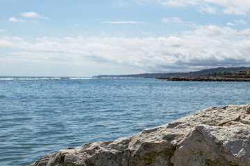 Stone texture in the foreground against the sea