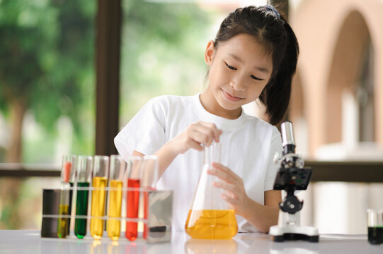 Asian girls having fun experimenting with science.