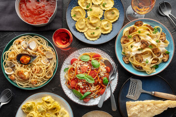 Pasta variety. Italian food and drinks, overhead flat lay shot on a black background. Spaghetti marinara, mushroom pappardelle, seafood pasta etc - obrazy, fototapety, plakaty