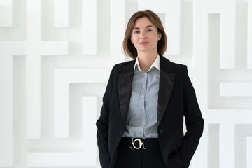 Portrait of attractive and smiling business woman standing in the office	