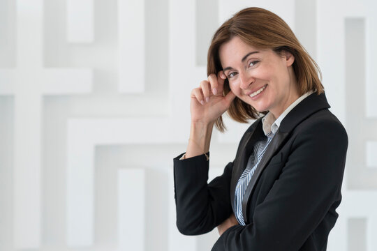 Portrait of attractive and smiling business woman standing in the office	