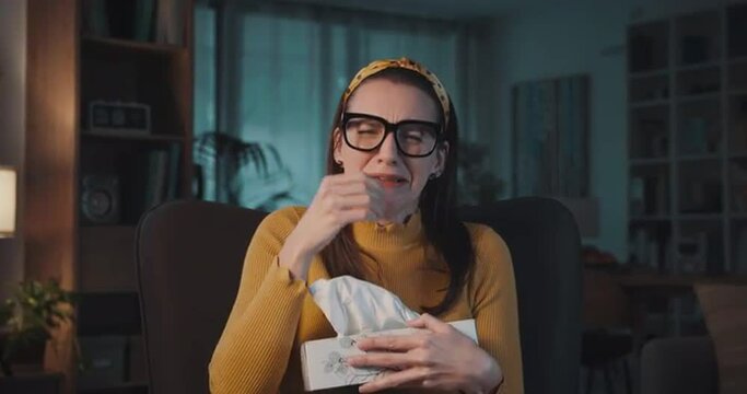 Emotional woman watching a drama movie on TV