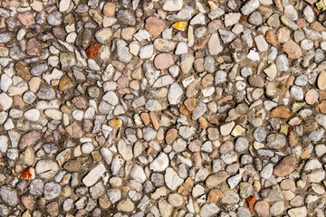 A sidewalk of small stones. Fine pebble texture.