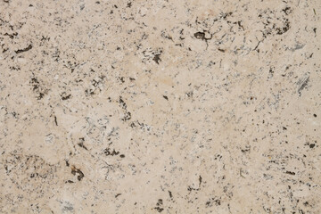 The texture of the stone is notched and mottled. holes notches grooves on the stone.