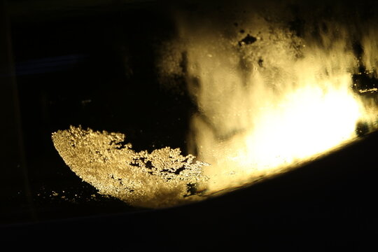abstract image of backlit wine tartrate crystals in a bottle of white wine