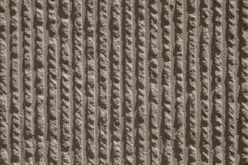 the texture of a plaster or wall with small indentations.