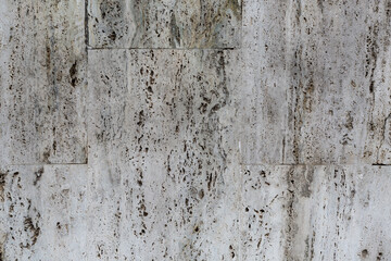 Texturized stone wall weathered and aged.