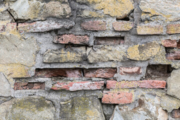 Texturized brick wall with some of them broken.