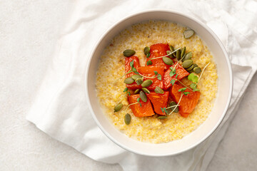 Portion of healthy breakfast millet porridge with baked pumpkin