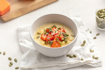 Portion of healthy breakfast millet porridge with baked pumpkin