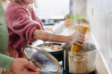Senior couple cooking together in their kitchen.