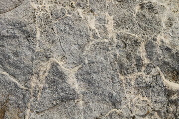 The texture of the stone is notched and mottled. holes notches grooves on the stone.