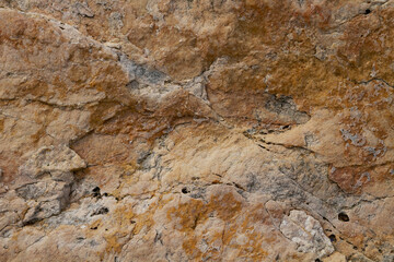 The texture of the stone is notched and mottled. holes notches grooves on the stone.