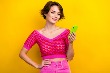 Portrait of lovely pretty adorable lady wear trendy pink clothes use iphone device gadget isolated on yellow color background