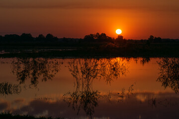 Naklejka premium sunset over the river