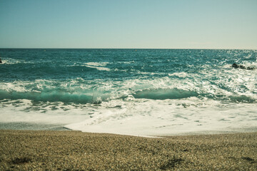 Fototapeta na wymiar Front view of turquoise ocean water and horizon in Spain