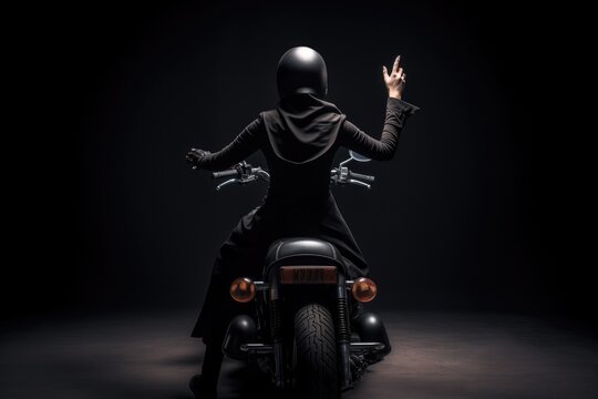 a motorcyclist in a sleek black outfit riding on an open road