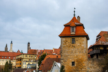 Fototapeta na wymiar View of the town wall and Kobolzeller Turm in Rothenburg ob der Tauber, the Franconia region of Bavaria, Germany. Medieval old town. The most romantic town in Germany.