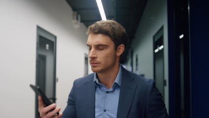 Fototapeta premium Worried businessman making call leaving office closeup. Stressed investor walk
