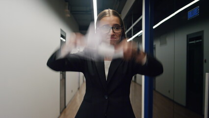 Fototapeta na wymiar Unhappy businesswoman throwing documents in office corridor. Upset girl walking
