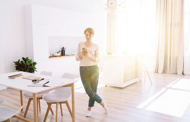 Woman using smartphone at home office