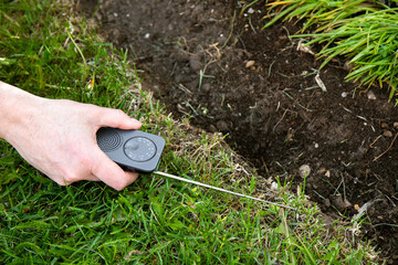 How do you find a break in a robotic mower perimeter wire. Person man hand using AM radio...