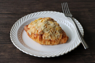 Delicious almond croissants in a white plate. French breakfast. 